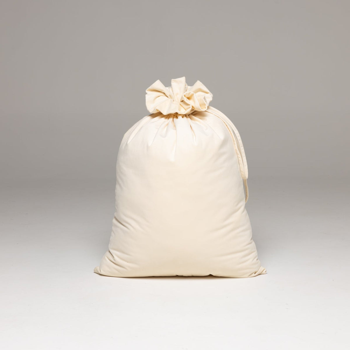 An off-white drawstring bag with a gathered top
